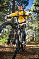 Male mountain biker riding bicycle in the forest