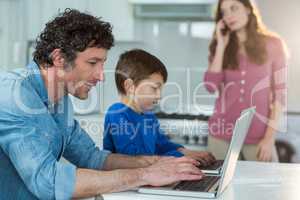 Father and son using laptop