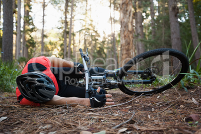Male mountain biker fallen from his bicycle in the forest