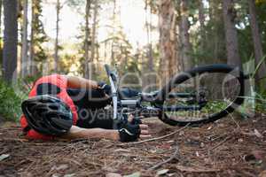 Male mountain biker fallen from his bicycle in the forest