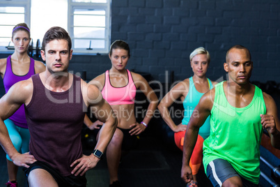 Determined athletes exercising in gym