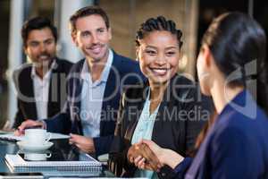 Businesswoman shaking hands with colleague