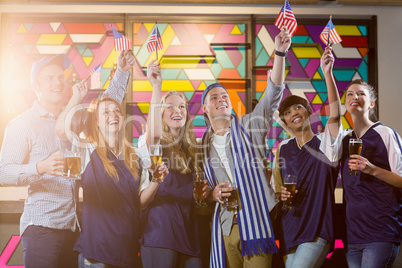 Group of friends toasting glass of beer in party