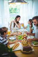 Happy family having breakfast together