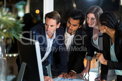 Group of businesspeople looking at computer