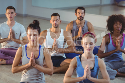 Group of people performing yoga