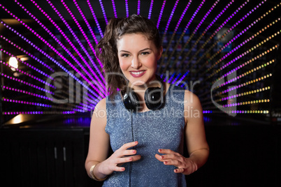 Pretty female DJ playing music