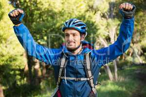 Excited male mountain biker in the forest