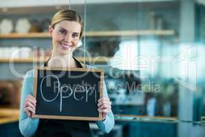 Waiter and waitress using digital tablet in cafÃ?Â©