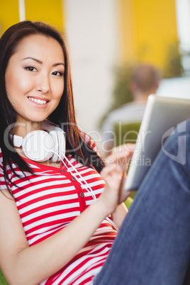 Portrait of happy executive using tablet at creative office