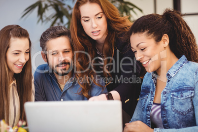 Businesswoman discussing with coworkers