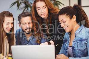 Businesswoman discussing with coworkers