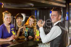 Portrait of waiter and beautiful woman standing at bar counter