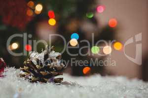 Christmas bauble and pine cone on snow