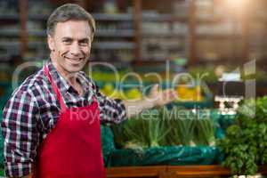 Smiling male staff showing organic section