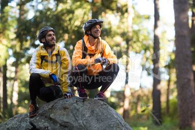 Biker couple looking at a view in forest