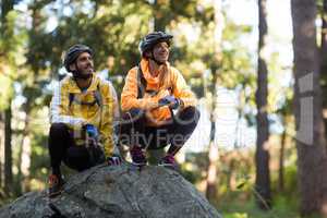 Biker couple looking at a view in forest