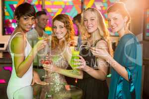 Group of friends having glass of cocktail in bar