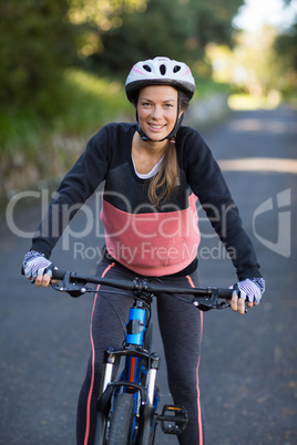 Female biker with mountain bike in countryside Female biker with mountain bike in countryside