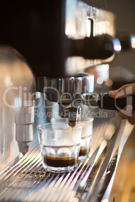 Waitress making cup of coffee