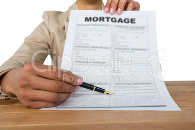 Mid section of businesswoman showing mortgage contract