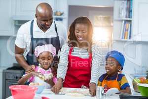 Family preparing cake