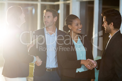 Group of businesspeople shaking hands with each other