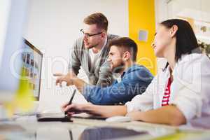 Colleagues discussing photographs at creative office