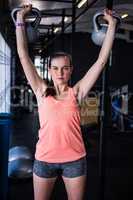 Portrait of young athlete holding kettlebell