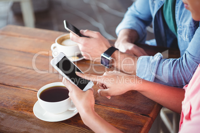 Hands of couple using mobile phone