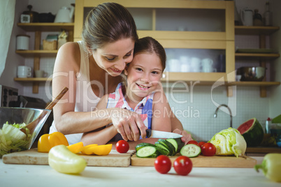 Mother and daughter preparing salad