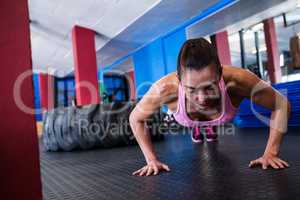 Young female athlete doing push-ups