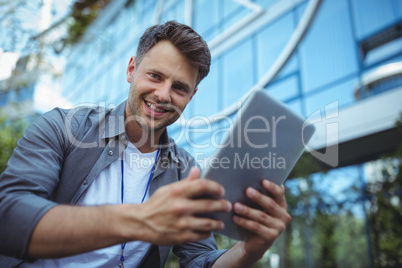 Portrait of business executive using digital tablet