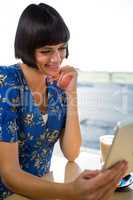Woman using a digital tablet in the coffee shop