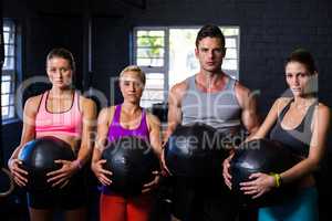 Determined athletes with fitness ball