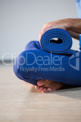 Man holding exercise mat