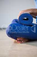 Man holding exercise mat