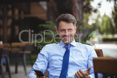 Businessman showing thumbs up