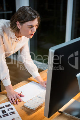 Businesswoman working on computer at her desk