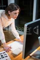 Businesswoman working on computer at her desk