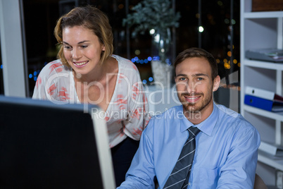 Business executives working on computer