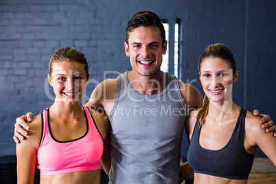 Male and female athletes against wall