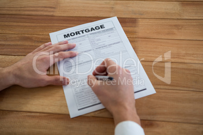 Businessman filling mortgage contract form