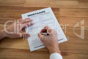 Businessman filling mortgage contract form