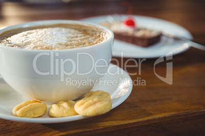 Cappuccino with cookies on plate