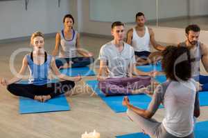 Instructor taking yoga class