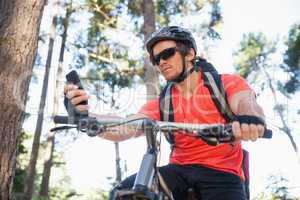 Mountain biker using mobile phone