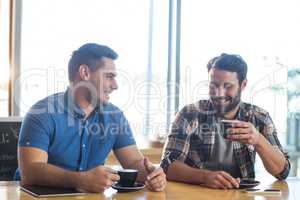 Male friends having a cup of coffee in cafÃ?Â©