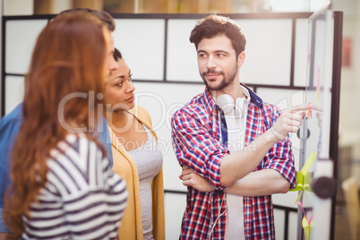 Confident executive interacting in meeting room at creative office