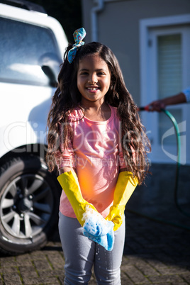 Daughter holding sponge